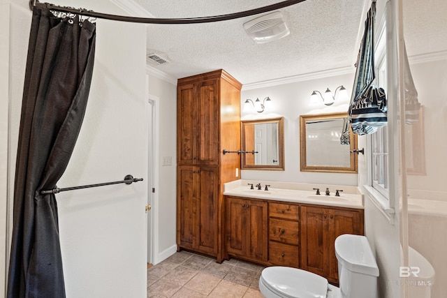 606 Fairhope Ave, Fairhope, AL 36532 - full bath with toilet, double vanity, ornamental molding, tile patterned flooring, and a textured ceiling