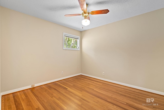 606 Fairhope Ave, Fairhope, AL 36532 - spare room featuring baseboards, light wood-type flooring, a ceiling fan, and a textured ceiling