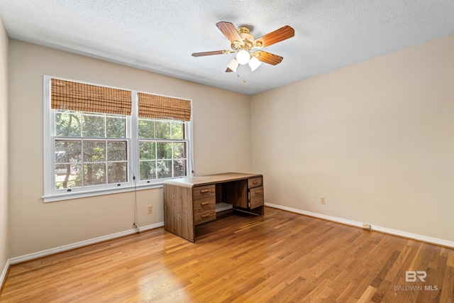 606 Fairhope Ave, Fairhope, AL 36532 - unfurnished office with light wood-style flooring, a ceiling fan, a textured ceiling, and baseboards
