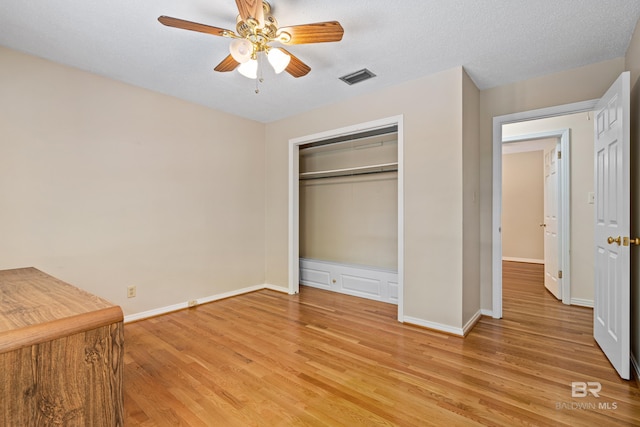 606 Fairhope Ave, Fairhope, AL 36532 - unfurnished bedroom with light wood-type flooring, a closet, a ceiling fan, and baseboards