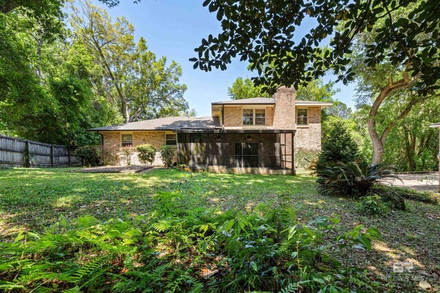 606 Fairhope Ave, Fairhope, AL 36532 - back of house with a chimney and brick siding