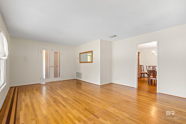 606 Fairhope Ave, Fairhope, AL 36532 - unfurnished room with light wood finished floors, baseboards, and french doors