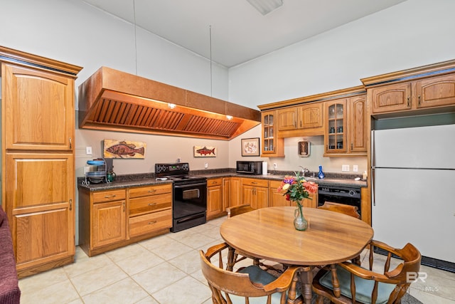 606 Fairhope Ave, Fairhope, AL 36532 - kitchen with black appliances, dark countertops, glass insert cabinets, light tile patterned floors, and custom exhaust hood