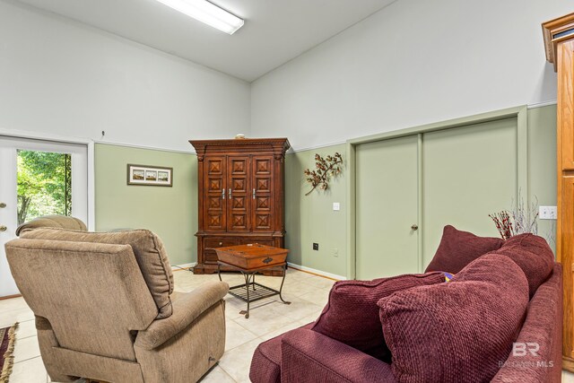 606 Fairhope Ave, Fairhope, AL 36532 - living room featuring high vaulted ceiling, light tile patterned floors, and baseboards