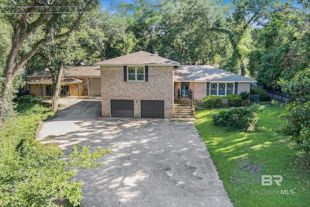 606 Fairhope Ave, Fairhope, AL 36532 - split level home with concrete driveway, a garage, and brick siding