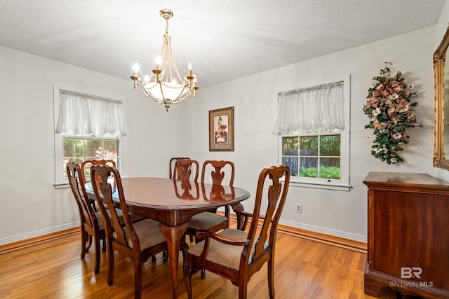 606 Fairhope Ave, Fairhope, AL 36532 - dining room with a chandelier, light wood-style floors, healthy amount of natural light, and baseboards