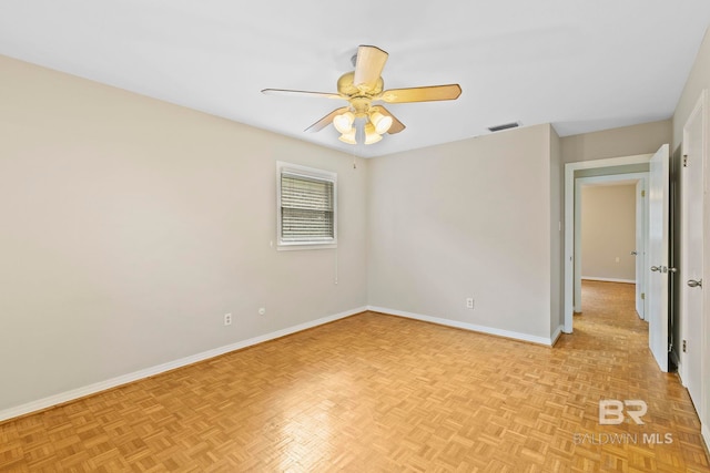 empty room featuring ceiling fan and light parquet floors