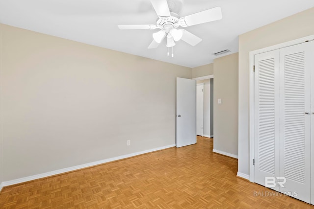 unfurnished bedroom with ceiling fan, a closet, and light parquet floors