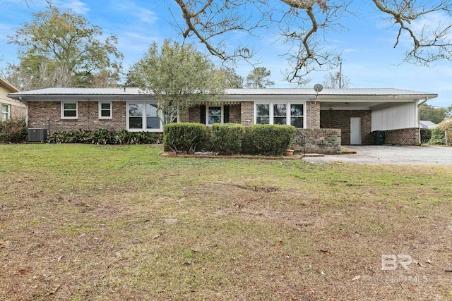 ranch-style home with a front lawn, a carport, and central air condition unit