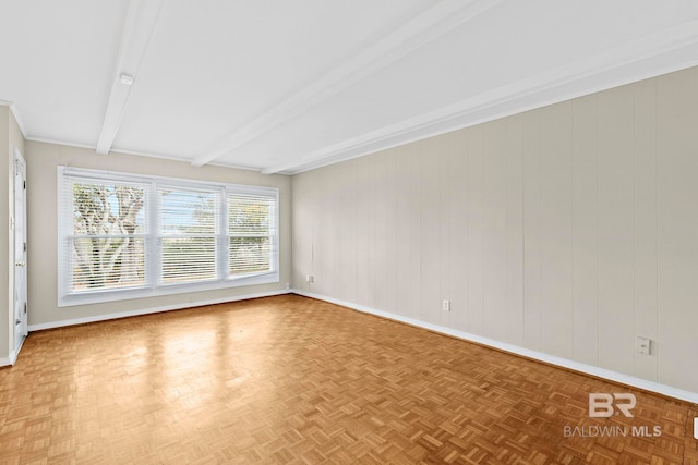 unfurnished room featuring beamed ceiling and parquet flooring