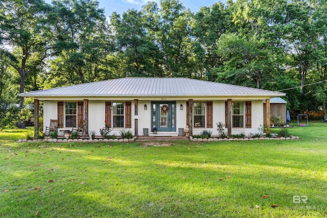ranch-style house featuring brick siding, covered porch, and a front lawn