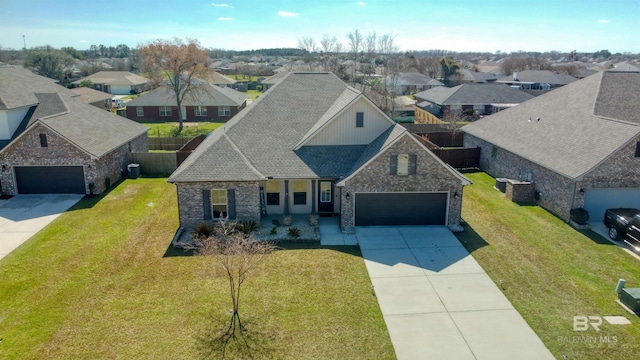 view of front of property with a shingled roof, a front lawn, and a residential view