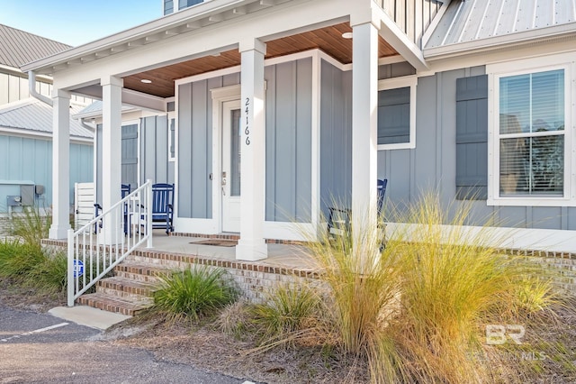 view of exterior entry featuring a porch