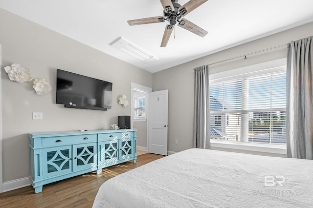 bedroom with ceiling fan and dark hardwood / wood-style floors