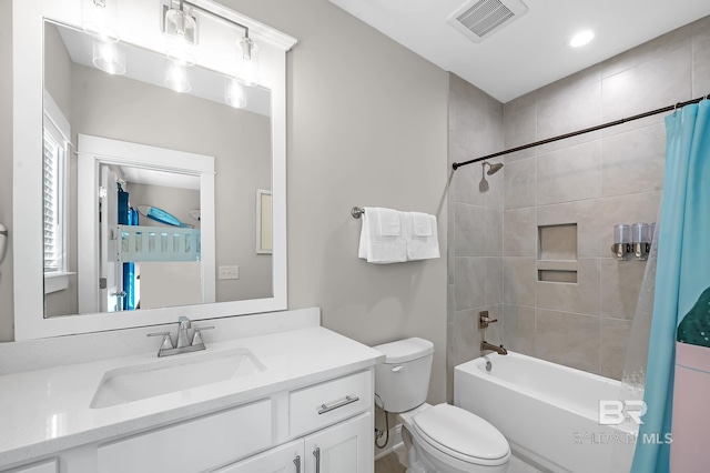 full bathroom featuring shower / bath combo with shower curtain, vanity, and toilet