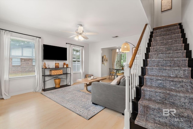 living room with ceiling fan and hardwood / wood-style floors