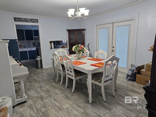 dining space with an inviting chandelier, french doors, ornamental molding, and a textured ceiling