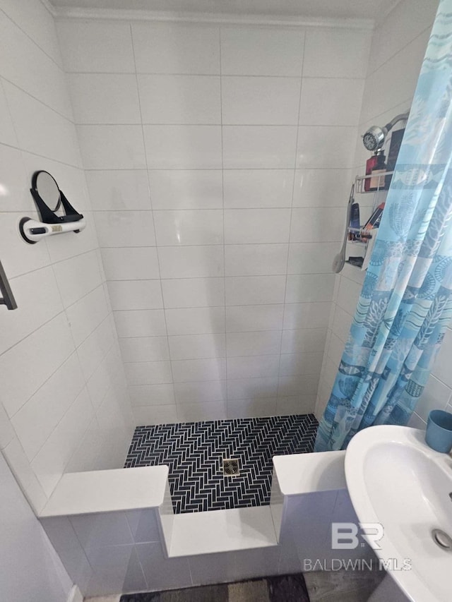 bathroom with a shower with shower curtain and sink