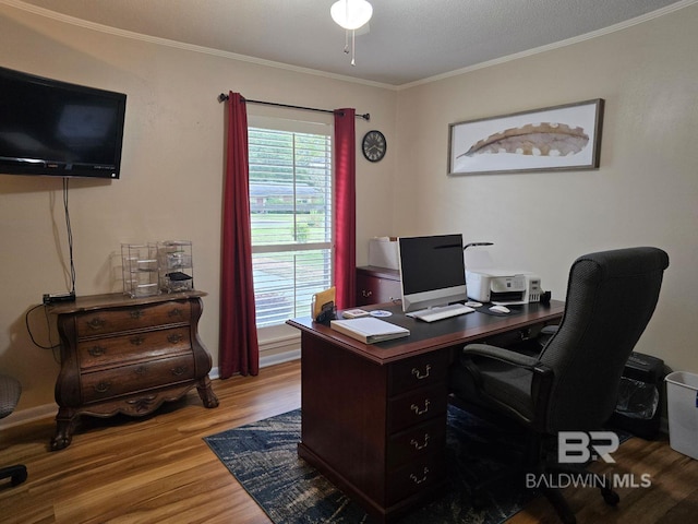 office area with ornamental molding, ceiling fan, wood-type flooring, and a textured ceiling