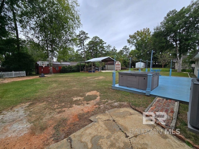 view of yard featuring a patio and a storage unit