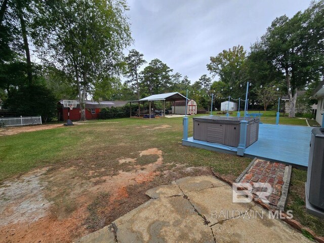 1411 Mcmillan Ave, Brewton, AL 36426 - view of yard with a shed, a detached carport, an outbuilding, and a hot tub