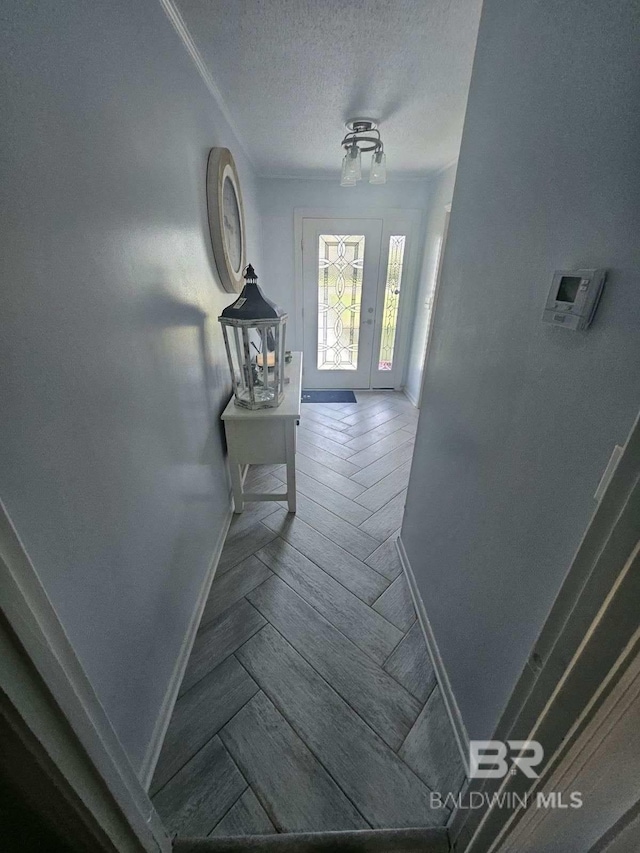 1411 Mcmillan Ave, Brewton, AL 36426 - hallway featuring baseboards, a textured ceiling, and wood finished floors