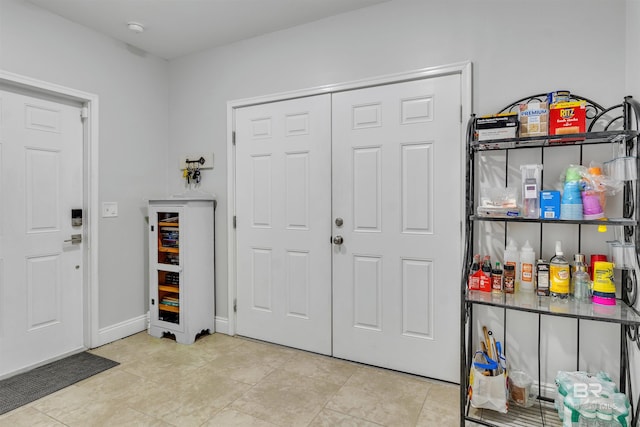 tiled foyer entrance featuring baseboards