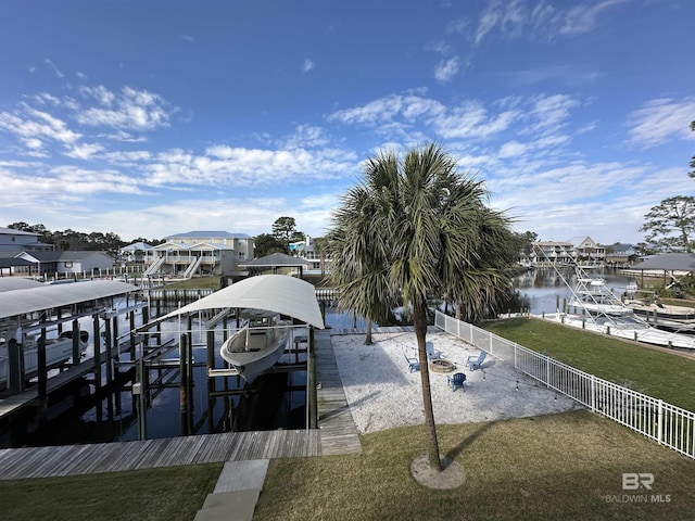 dock area featuring a water view, boat lift, a residential view, and fence