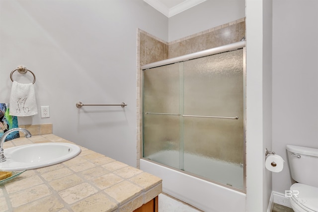 full bath featuring toilet, shower / bath combination with glass door, crown molding, and vanity