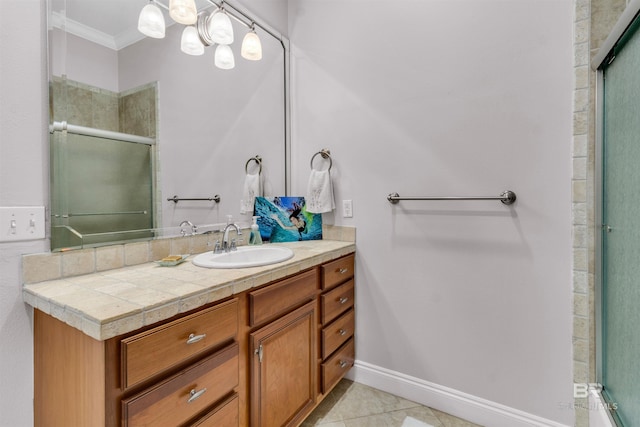 full bath with vanity, baseboards, tile patterned floors, an enclosed shower, and crown molding