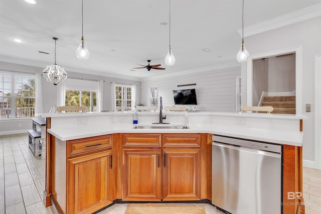 kitchen featuring light countertops, crown molding, stainless steel dishwasher, a sink, and ceiling fan with notable chandelier