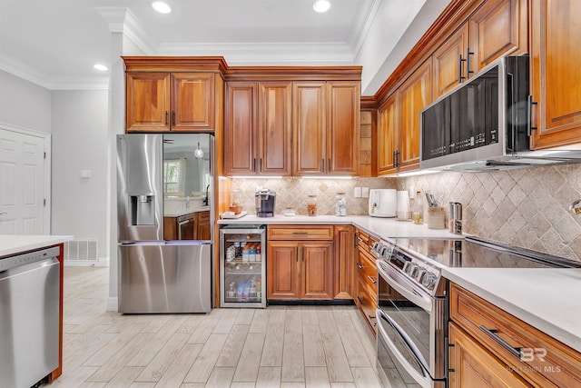 kitchen with brown cabinetry, wine cooler, visible vents, and stainless steel appliances