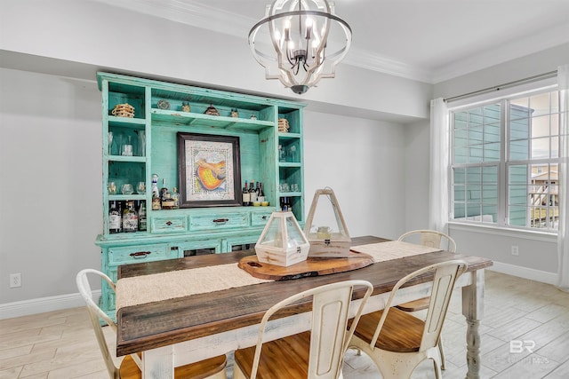 dining room with ornamental molding, light wood-type flooring, and an inviting chandelier