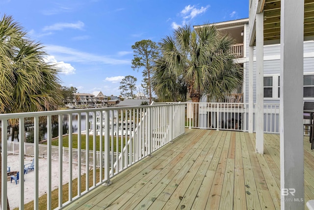 wooden terrace featuring a water view