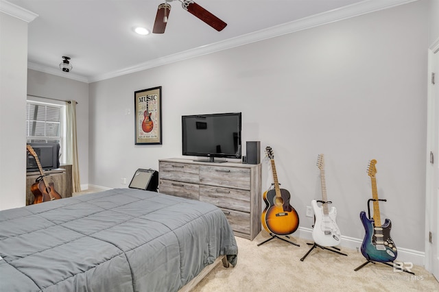 carpeted bedroom with baseboards, ornamental molding, and a ceiling fan