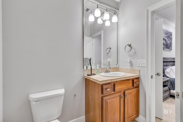 bathroom with vanity, ensuite bath, and toilet