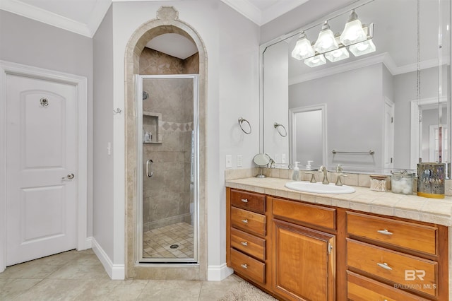 full bathroom with tile patterned flooring, vanity, baseboards, a shower stall, and crown molding