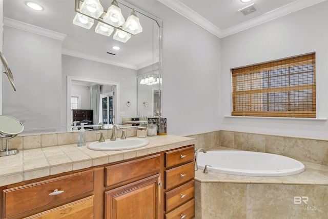 bathroom with a bath, visible vents, crown molding, and vanity