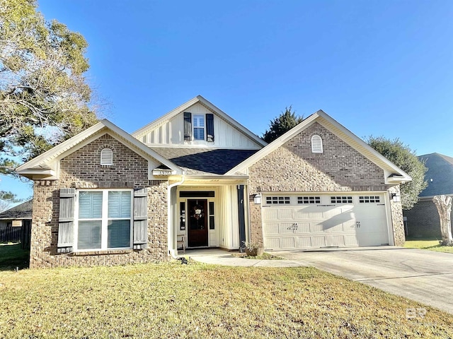 view of front facade with brick siding, a front yard, roof with shingles, driveway, and an attached garage