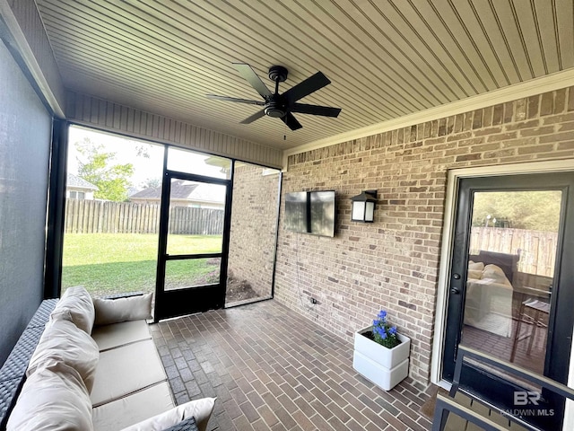 sunroom featuring ceiling fan