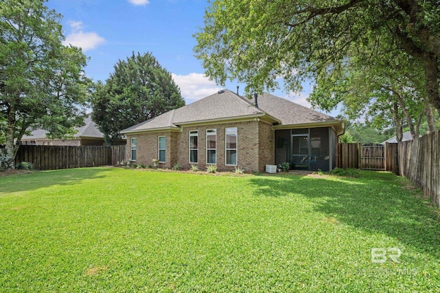 13713 Kearny Dr, Loxley, AL 36551 - back of property with a sunroom, brick siding, and roof with shingles