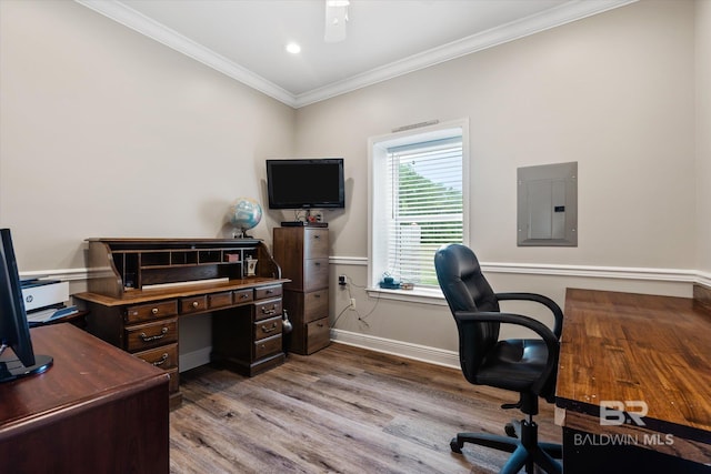 home office with ornamental molding, electric panel, and light hardwood / wood-style flooring