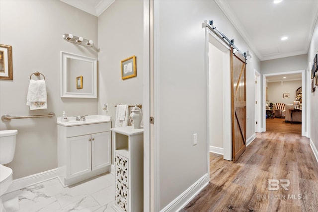 bathroom with ornamental molding, toilet, and vanity