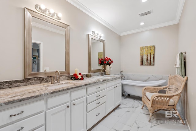 bathroom with crown molding, vanity, and a bathtub