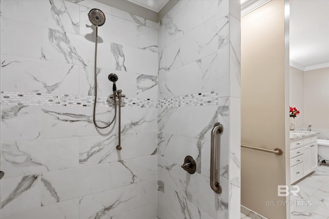 bathroom with crown molding, tiled shower, and vanity