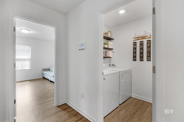 32299 Terranova Loop, Lillian, AL 36549 - washroom featuring washing machine and dryer, light wood finished floors, and baseboards