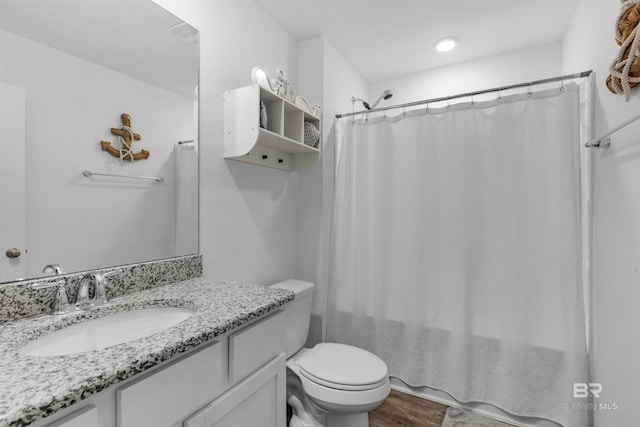 32299 Terranova Loop, Lillian, AL 36549 - bathroom featuring toilet, vanity, wood finished floors, and a shower with shower curtain