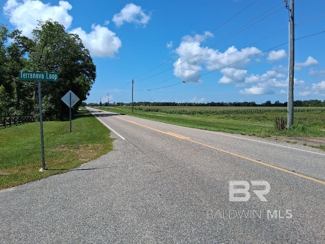 32299 Terranova Loop, Lillian, AL 36549 - view of asphalt street featuring a view of countryside and traffic signs