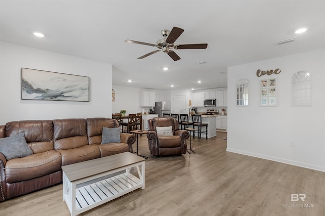 32299 Terranova Loop, Lillian, AL 36549 - living area with a ceiling fan, light wood-style flooring, recessed lighting, and baseboards