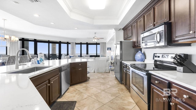 23450 Perdido Beach Blvd Unit 2011, Orange Beach, AL 36561 - kitchen featuring appliances with stainless steel finishes, a raised ceiling, open floor plan, dark brown cabinetry, and light tile patterned flooring